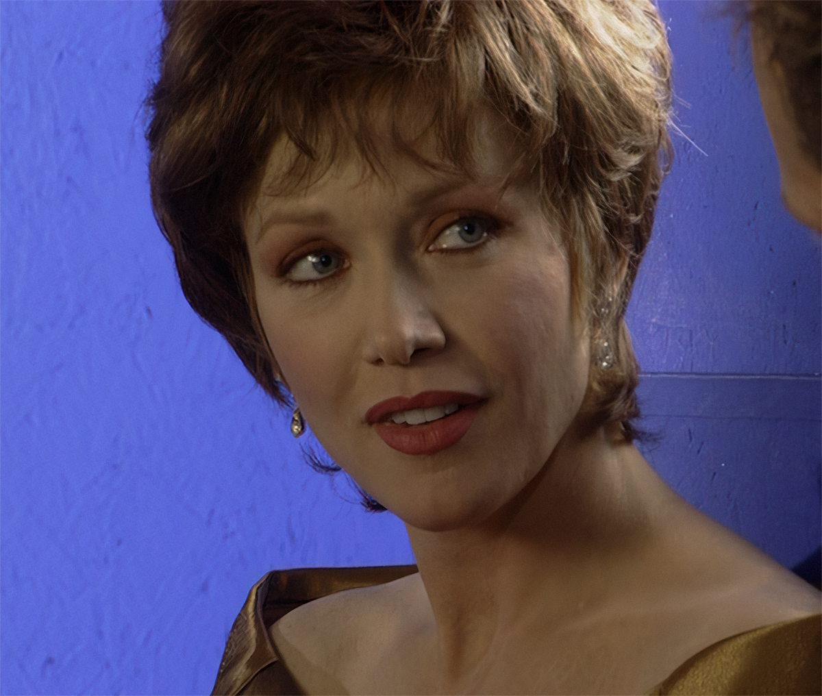 Upscaled image of Tanya Roberts on a blue screen background.