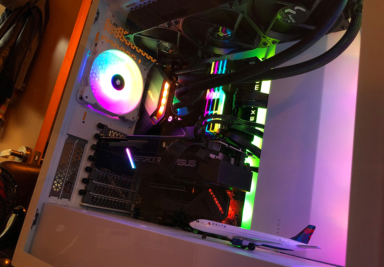 Image of the internals of the Core i9 RTX rendering PC being used to upscale the video footage with AI and machine learning. Plenty of RGB lighting inside, as well as a model of a Delta Airbus A320 plane.